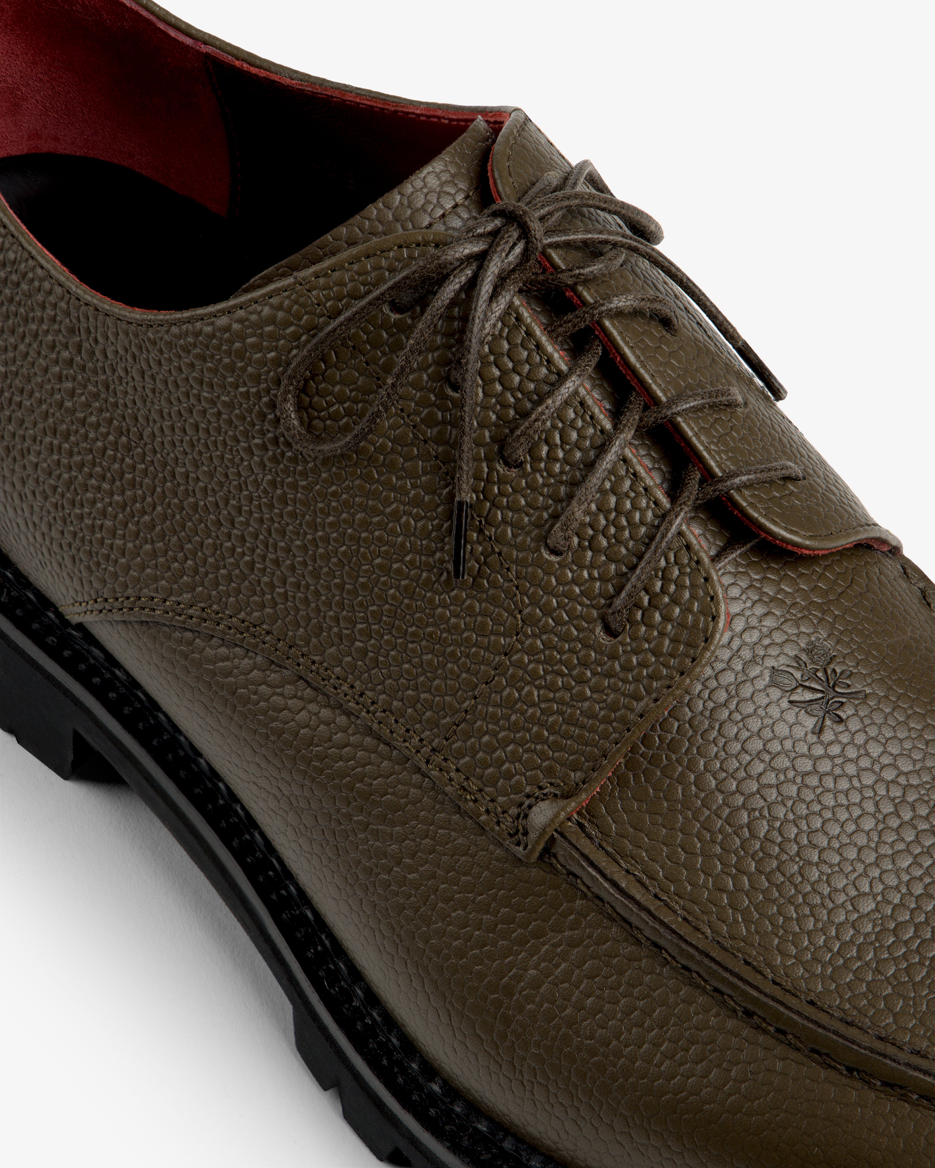 Leather Lug Sole Derby in olive green with a textured finish, dark brown laces, and a thick black lug sole.