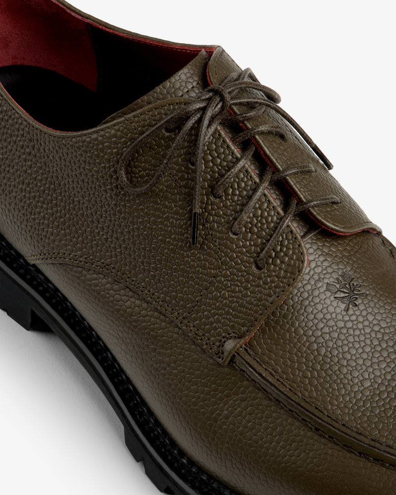 Leather Lug Sole Derby in olive green with a textured finish, dark brown laces, and a thick black lug sole.