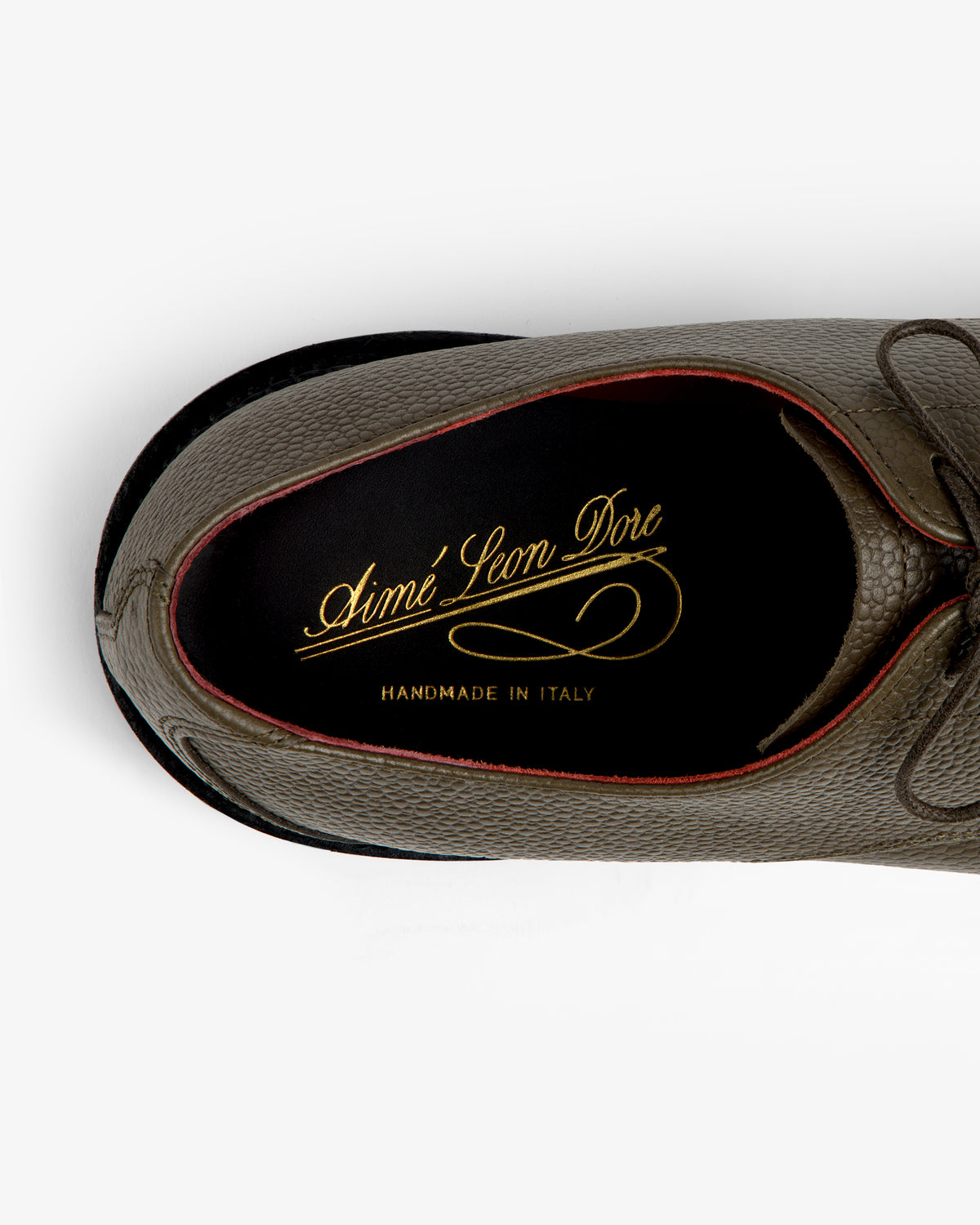 Top-down view of the Leather Lug Sole Derby, featuring a textured olive interior with gold logo branding.