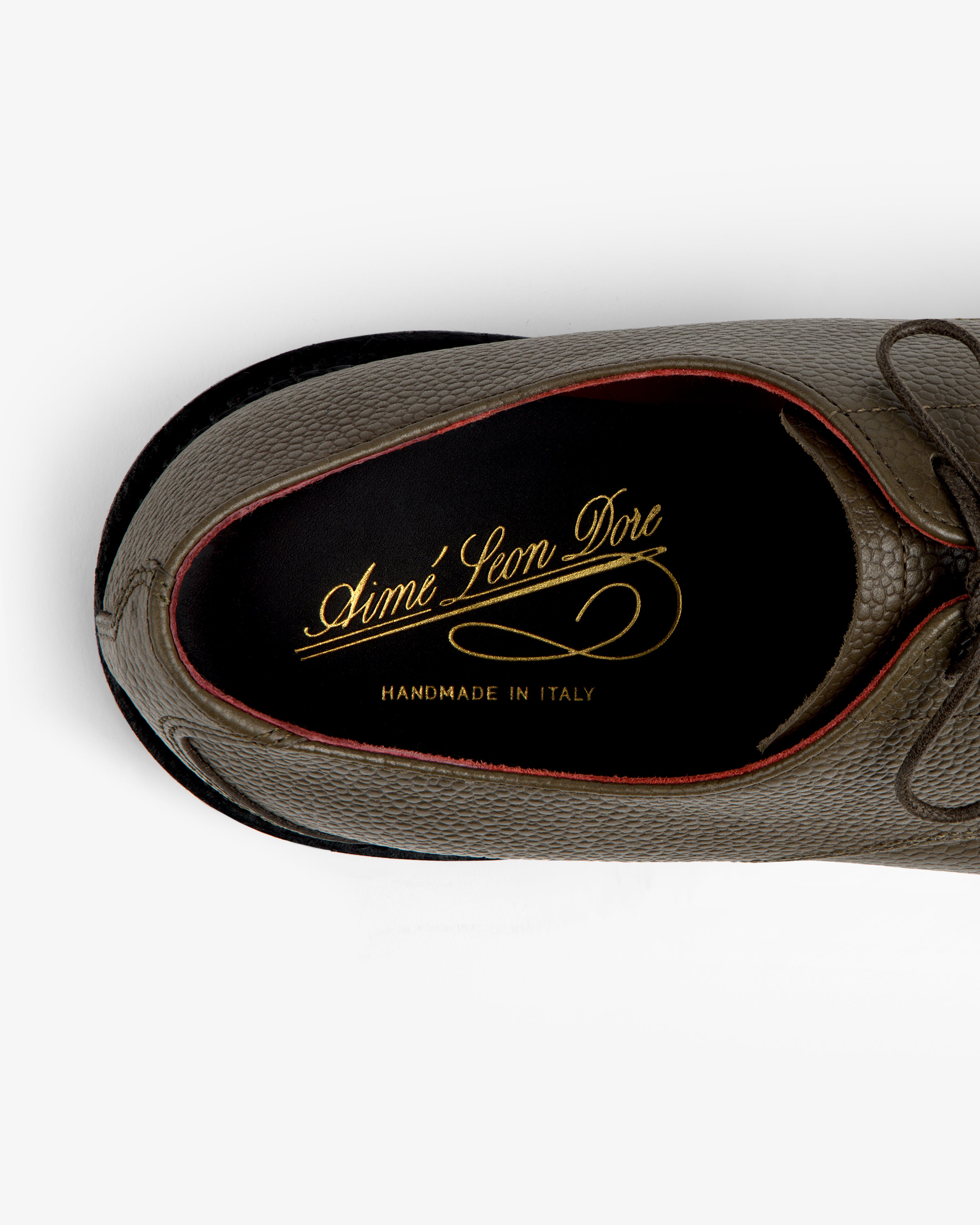 Top-down view of the Leather Lug Sole Derby, featuring a textured olive interior with gold logo branding.