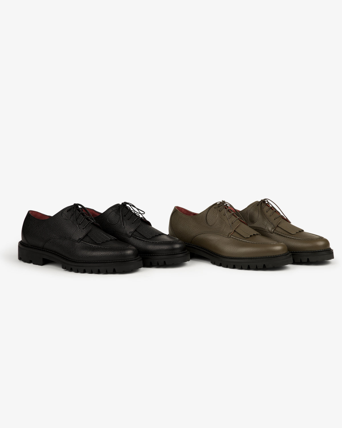 Two Leather Lug Sole Derby shoes, one black and one olive green, displayed side by side on a white background.