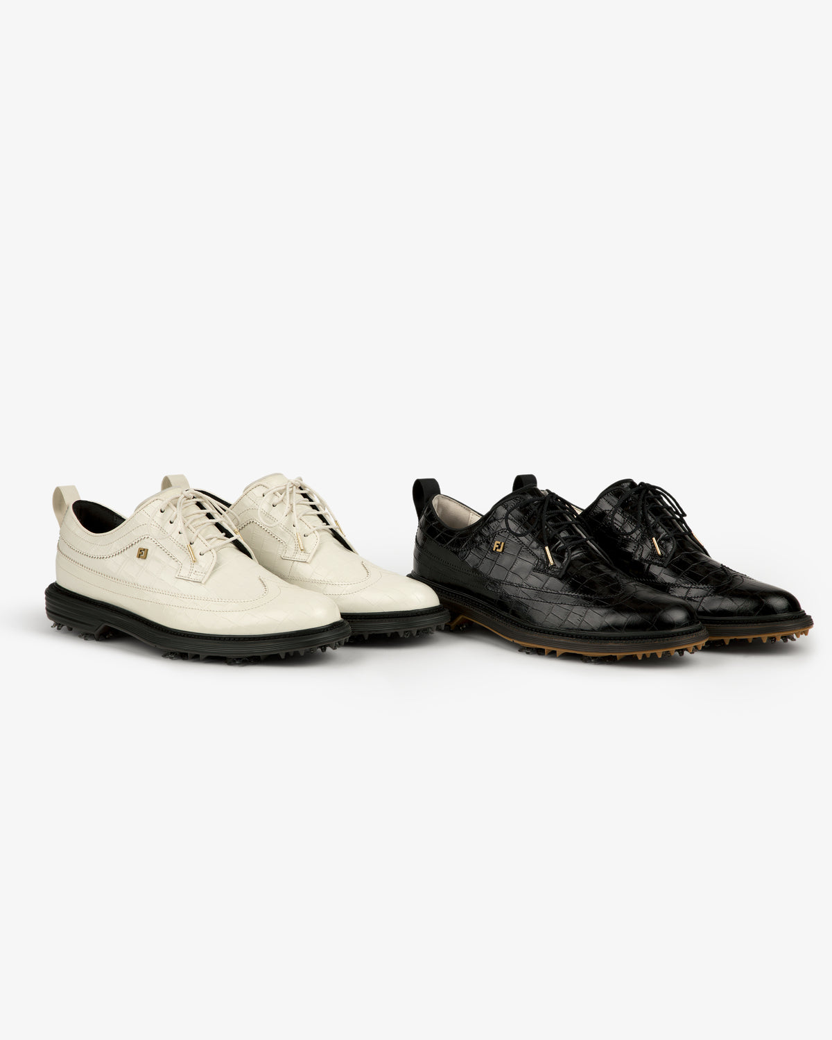 Two pairs of ALD / Footjoy Croc-Embossed Premiere Series Marquis shoes, one white and one black, side by side.