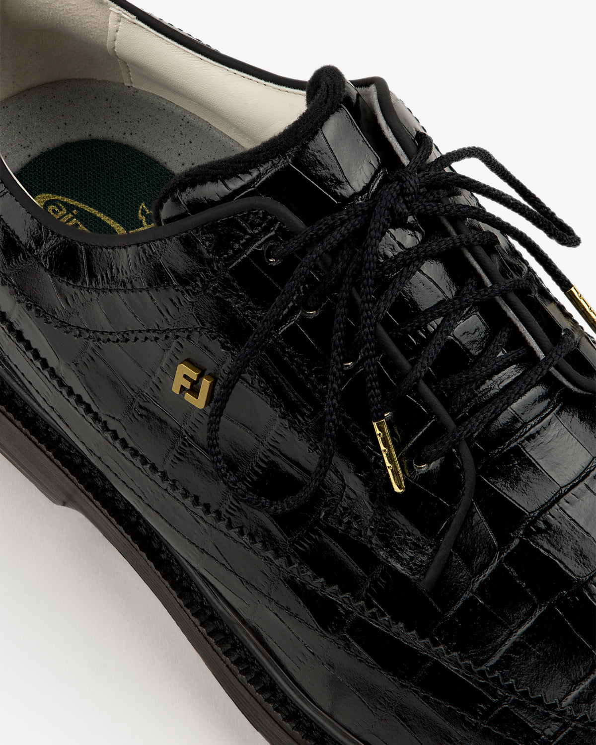Close-up of the ALD / Footjoy Croc-Embossed Premiere Series Marquis with black laces and gold FJ logo.