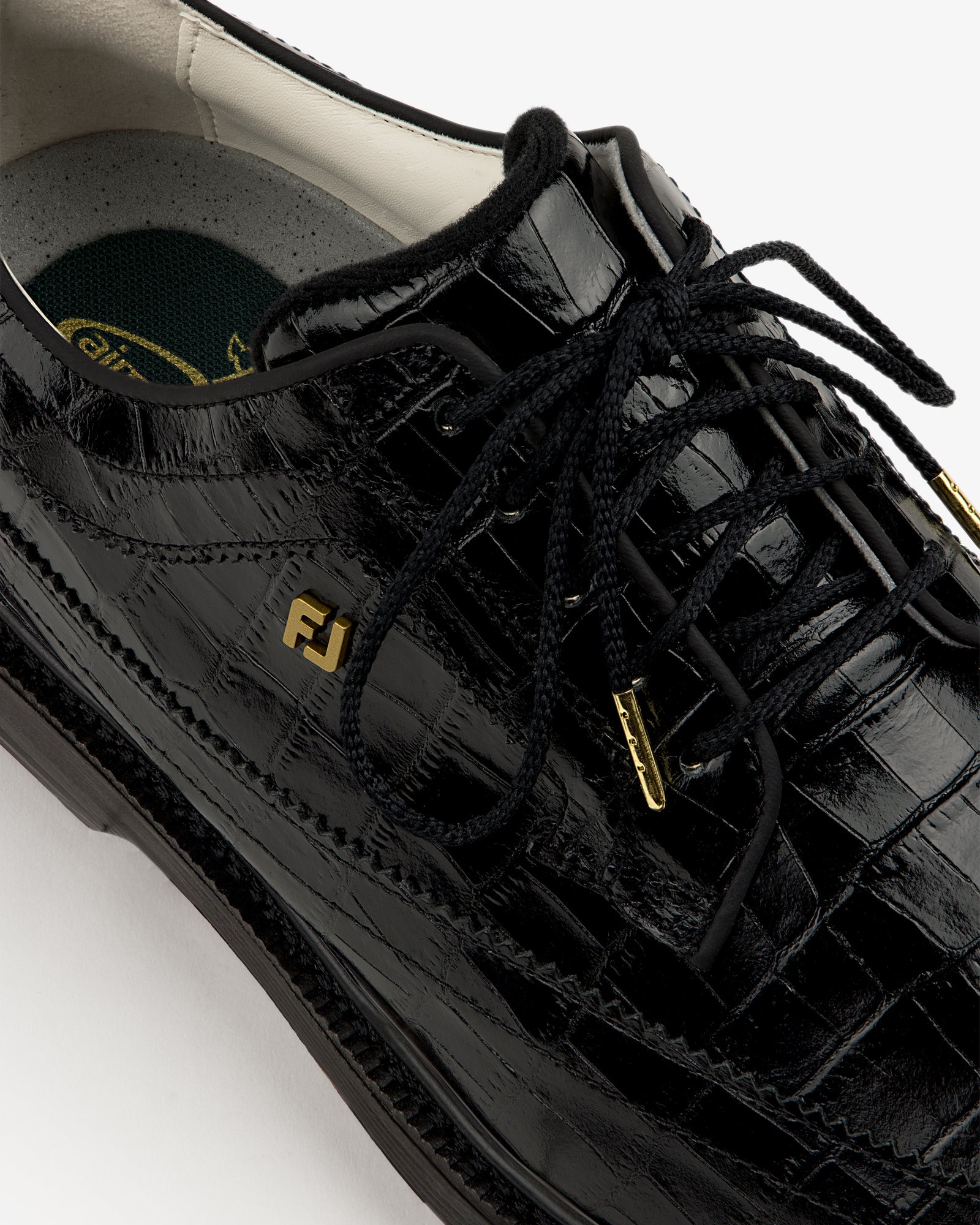 Close-up of the ALD / Footjoy Croc-Embossed Premiere Series Marquis with black laces and gold FJ logo.