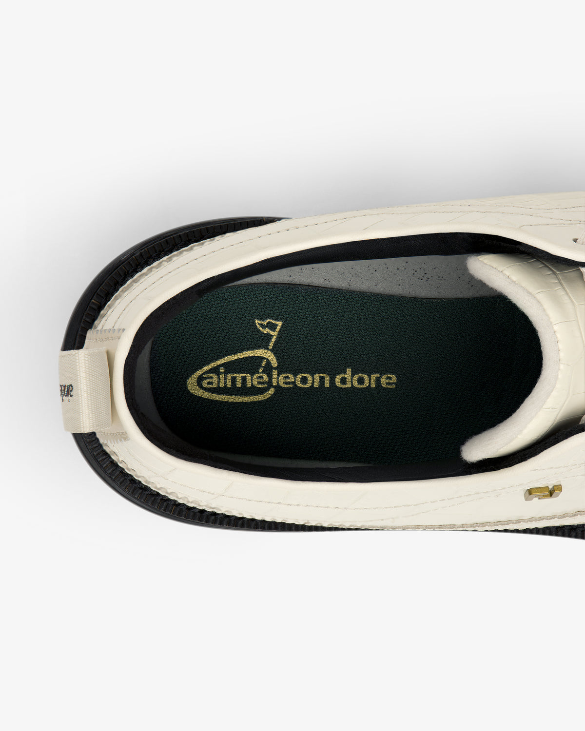 Top view of ALD / Footjoy Croc-Embossed Premiere Series Marquis with aimé leon dore in gold on the green insole.