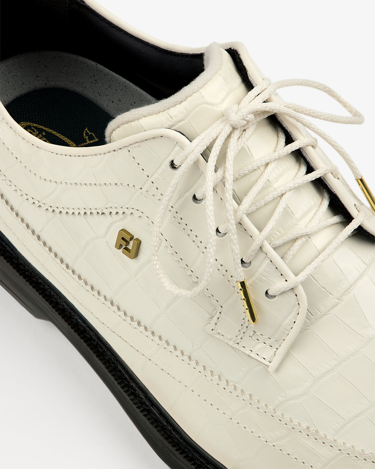 Close-up of the ALD / Footjoy Croc-Embossed Premiere Series Marquis with gold accents and black sole.
