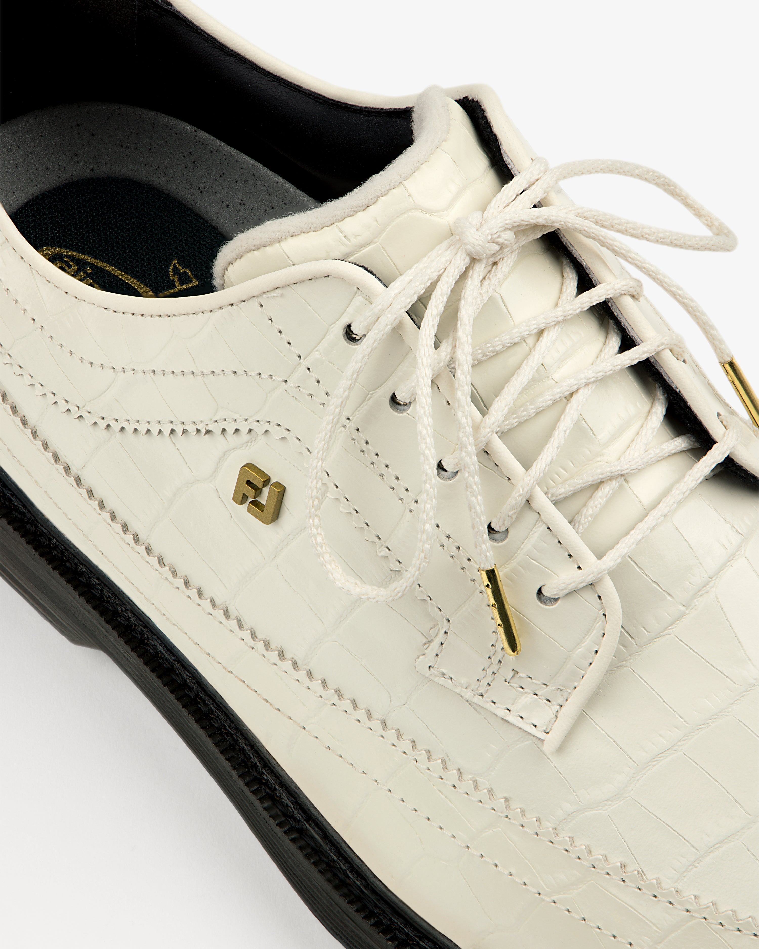 Close-up of the ALD / Footjoy Croc-Embossed Premiere Series Marquis with gold accents and black sole.