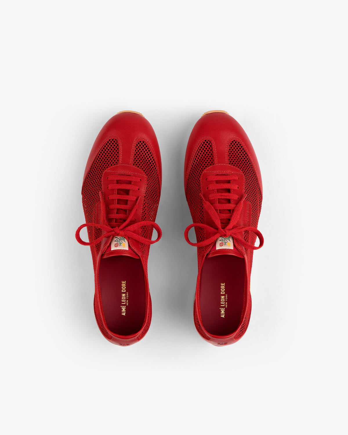 Low Profile Mesh Trainer sneakers in red with laces, top view on a white background.