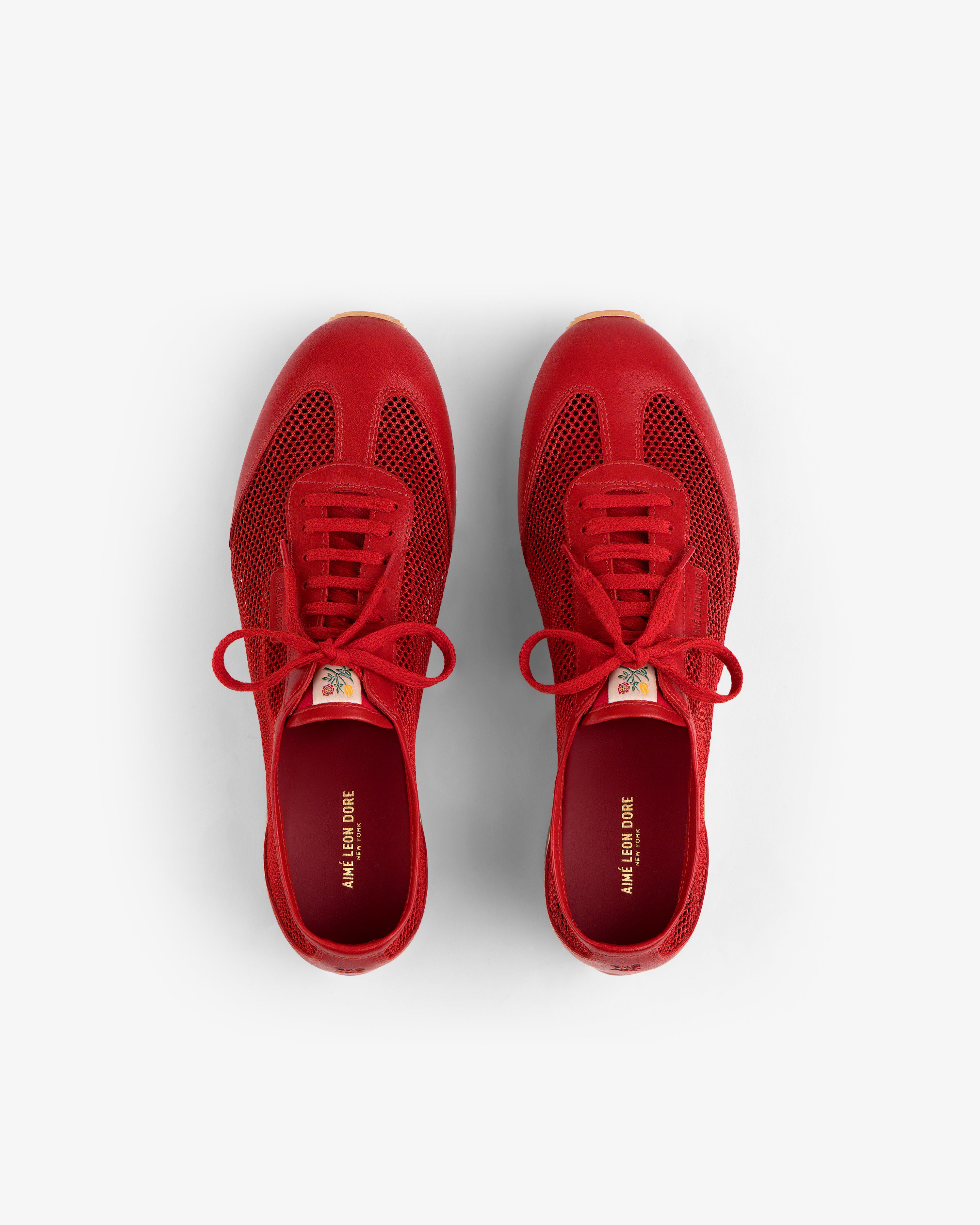 Low Profile Mesh Trainer sneakers in red with laces, top view on a white background.