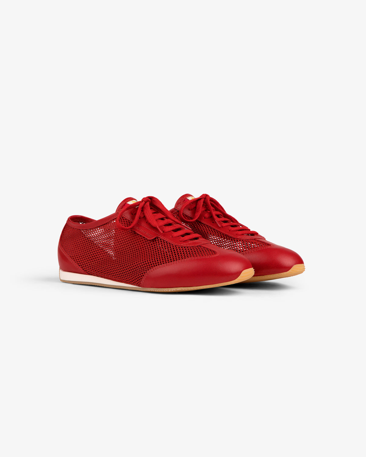 The Low Profile Mesh Trainer in red features lace-up design, mesh sides, and white soles on a plain white background.