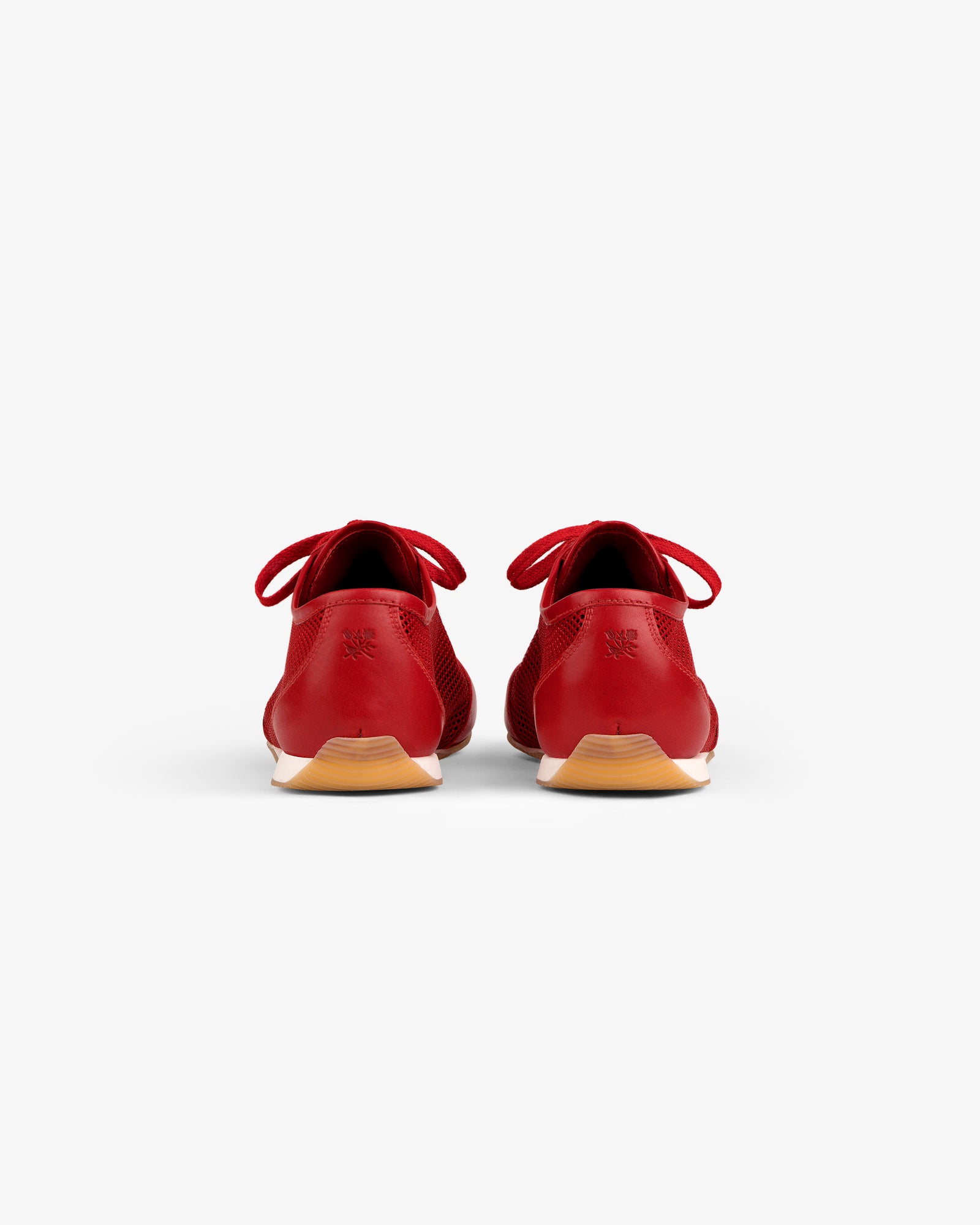 Back view of Low Profile Mesh Trainer in red with light brown soles and laces, set on a white background.