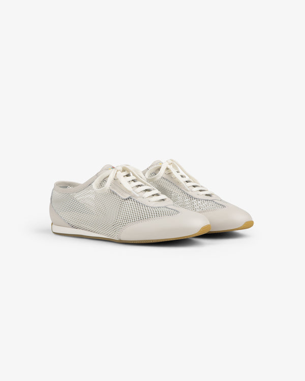 The Low Profile Mesh Trainer features white mesh, cream laces, and beige soles on a plain white background.