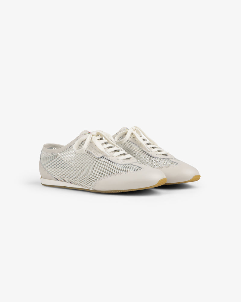 The Low Profile Mesh Trainer features white mesh, cream laces, and beige soles on a plain white background.