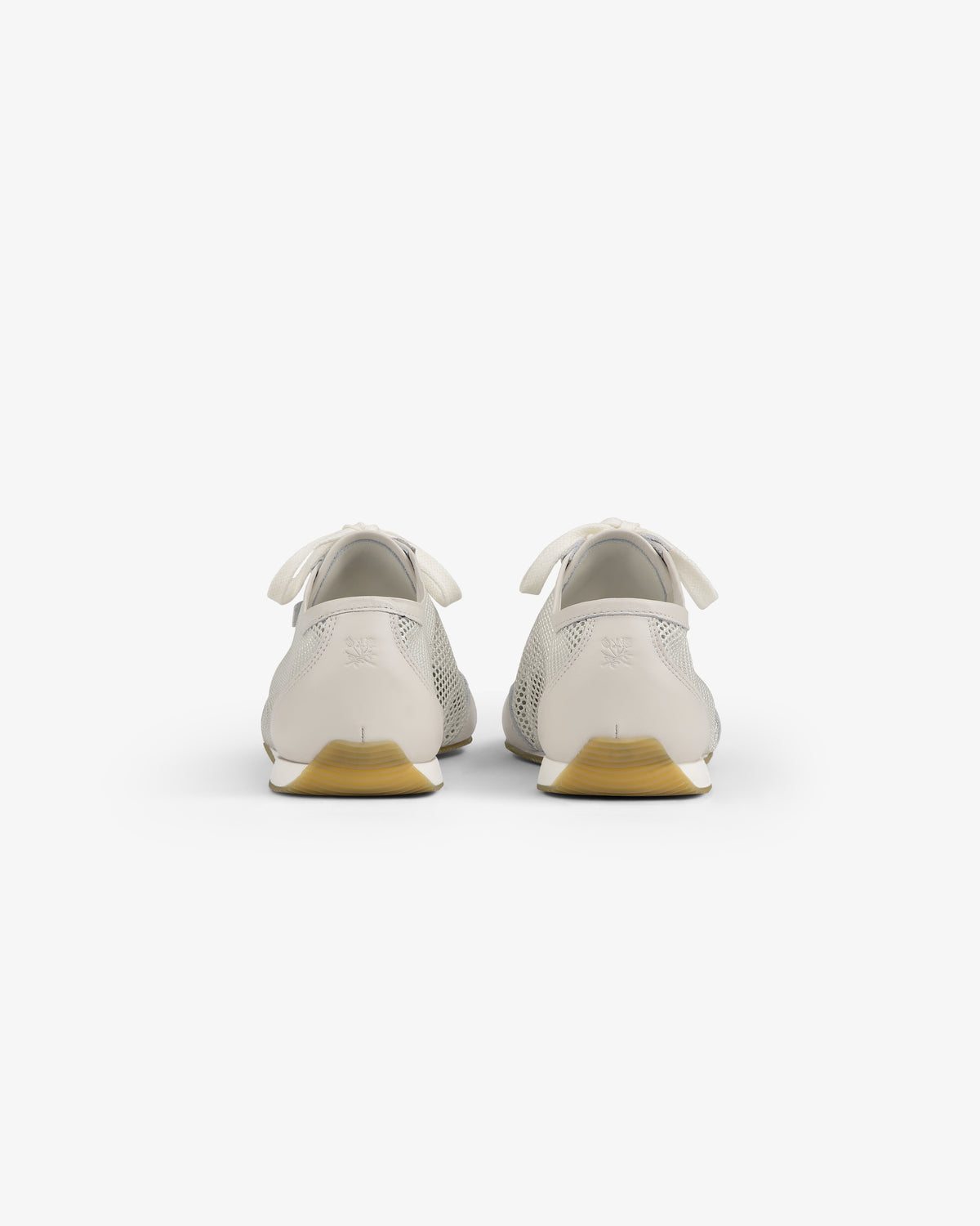 Back view of Low Profile Mesh Trainer in white with light brown soles and heel bows, on a white background.