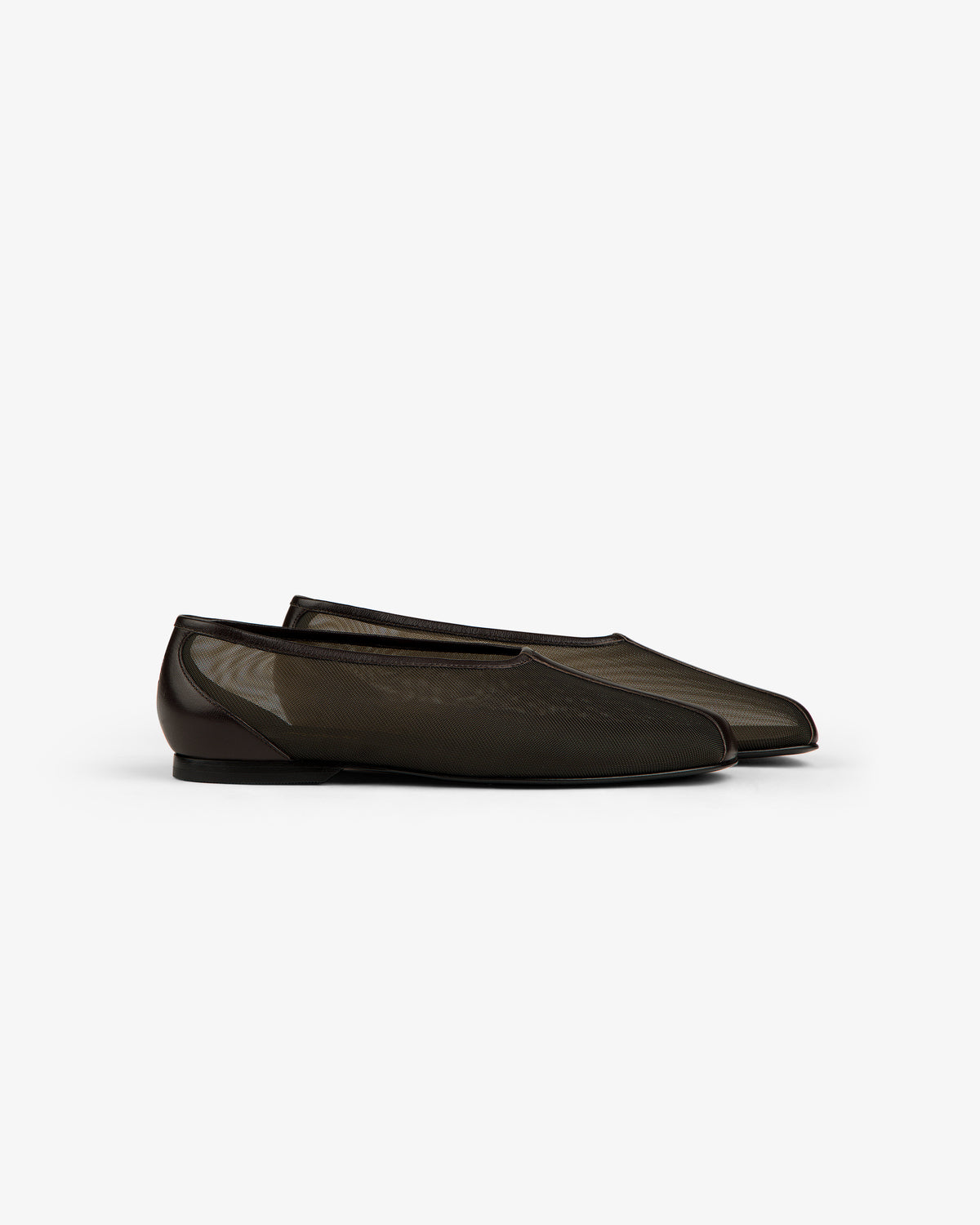 The Mesh Ballet Flat is a sheer black slip-on with a low heel, shown against a plain white background.