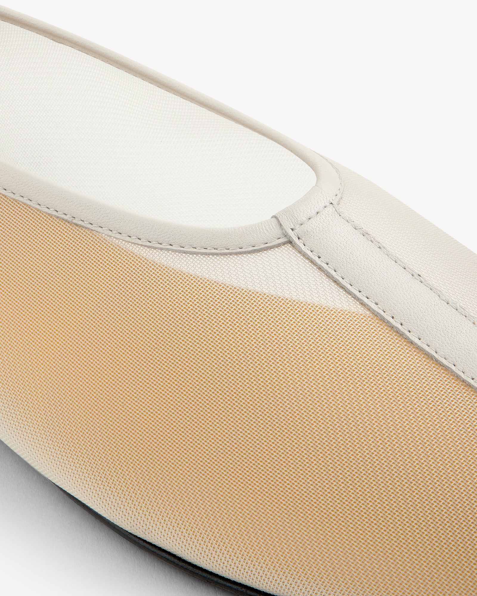 Close-up of the Mesh Ballet Flat, a beige and white slip-on with textured fabric and smooth leather trim.