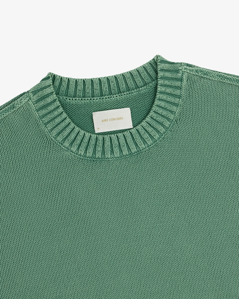 Washed Inside Out Sweater in green knit with ribbed crewneck, top view; label reads AIME LEON DORE.