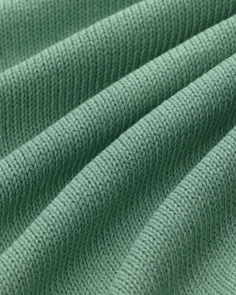 Close-up of green Washed Inside Out Sweater showing ribbed knit texture and evenly spaced raised ridges.