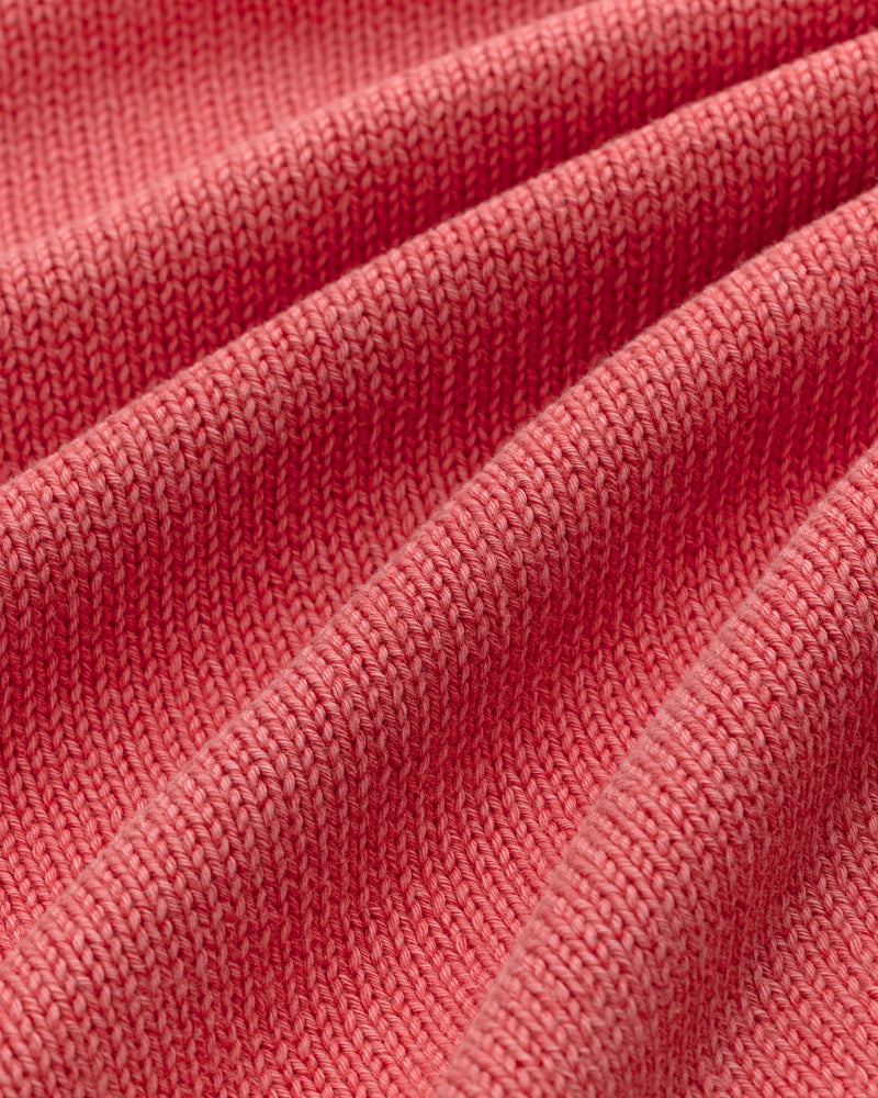 Close-up of the Washed Inside Out Sweater’s pink ribbed fabric with parallel raised, wavy lines.