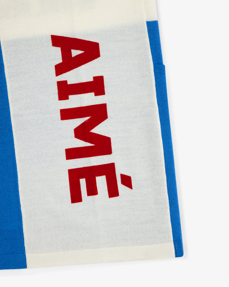 A white and blue Merino Wool Cycling Jersey with AIMÉ in bold red letters printed vertically.