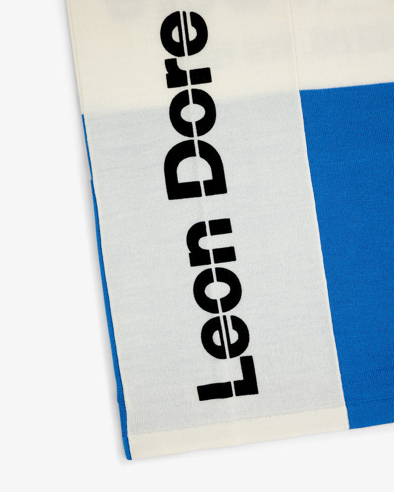 Close-up of Merino Wool Cycling Jersey with blue and white blocks and bold black vertical Leon Dore text.