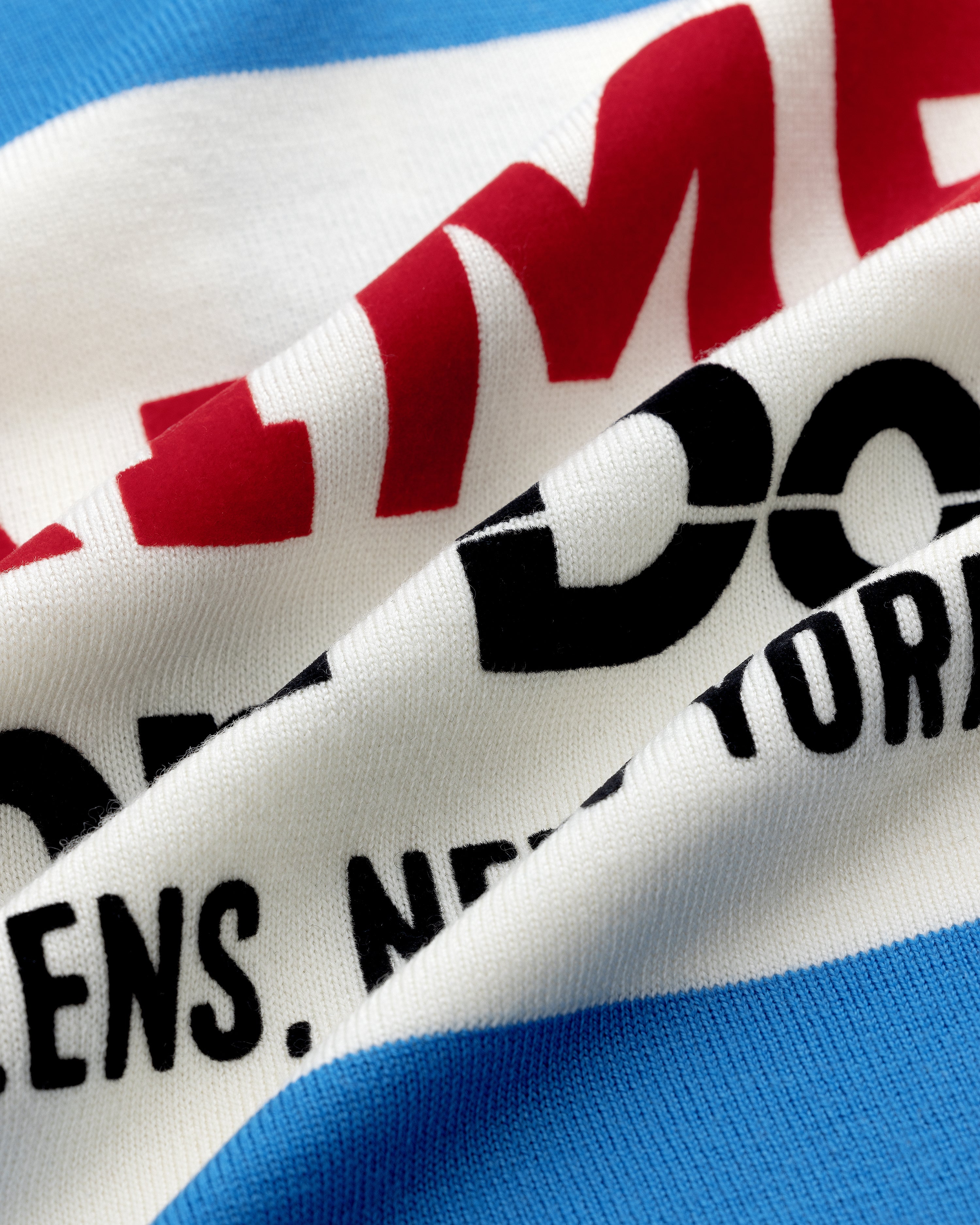 Close-up of Merino Wool Cycling Jersey with red and black NEW YORK text on white and blue striped fabric.