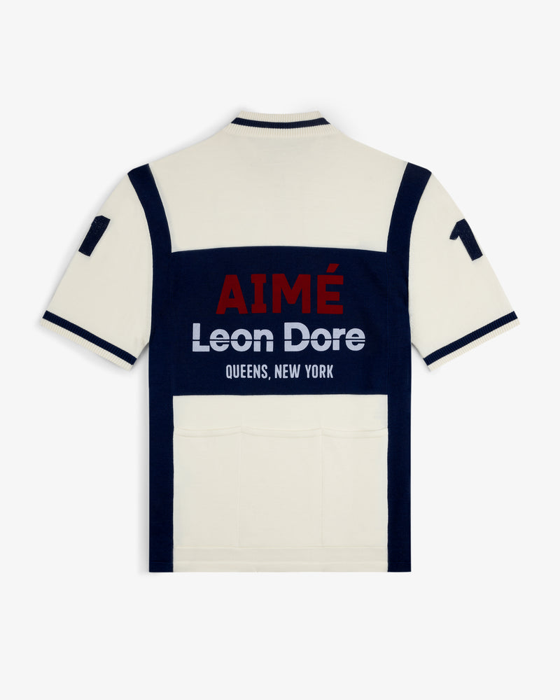 Merino Wool Cycling Jersey in cream/navy with “AIMÉ Leon Dore QUEENS, NEW YORK” text on the back.