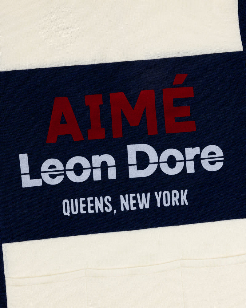 Navy and cream Merino Wool Cycling Jersey with AIMÉ Leon Dore QUEENS, NEW YORK in red and white block letters.