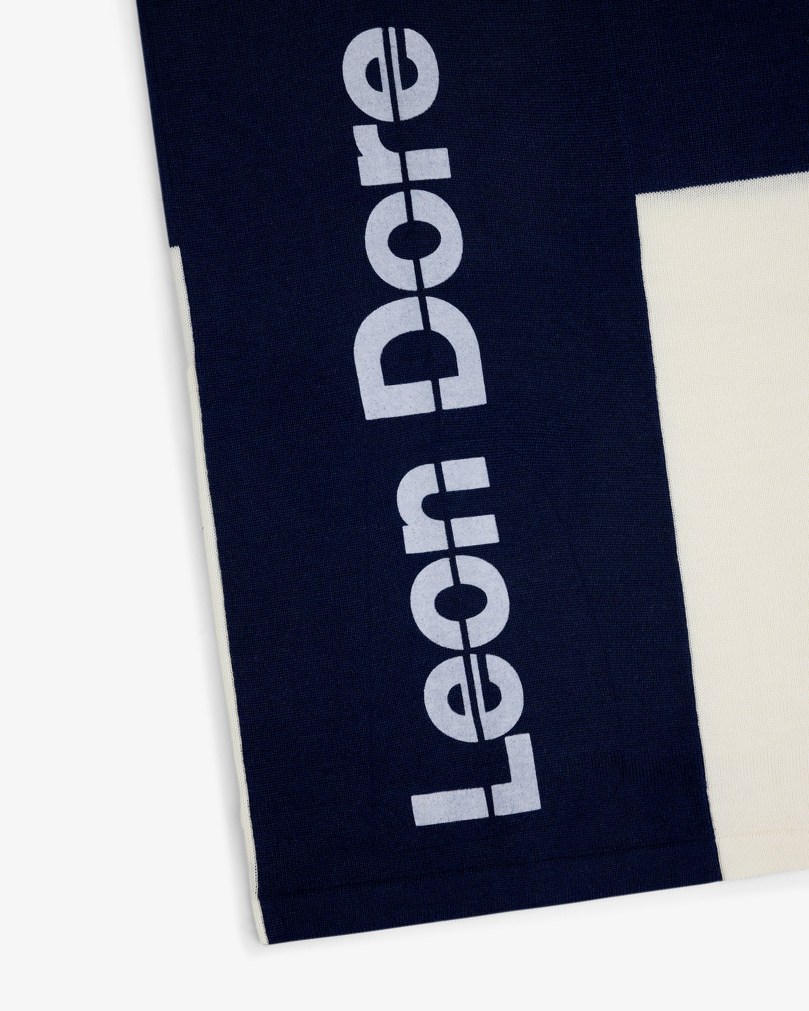 Navy Merino Wool Cycling Jersey with Leon Dore printed vertically in large white letters on the side.