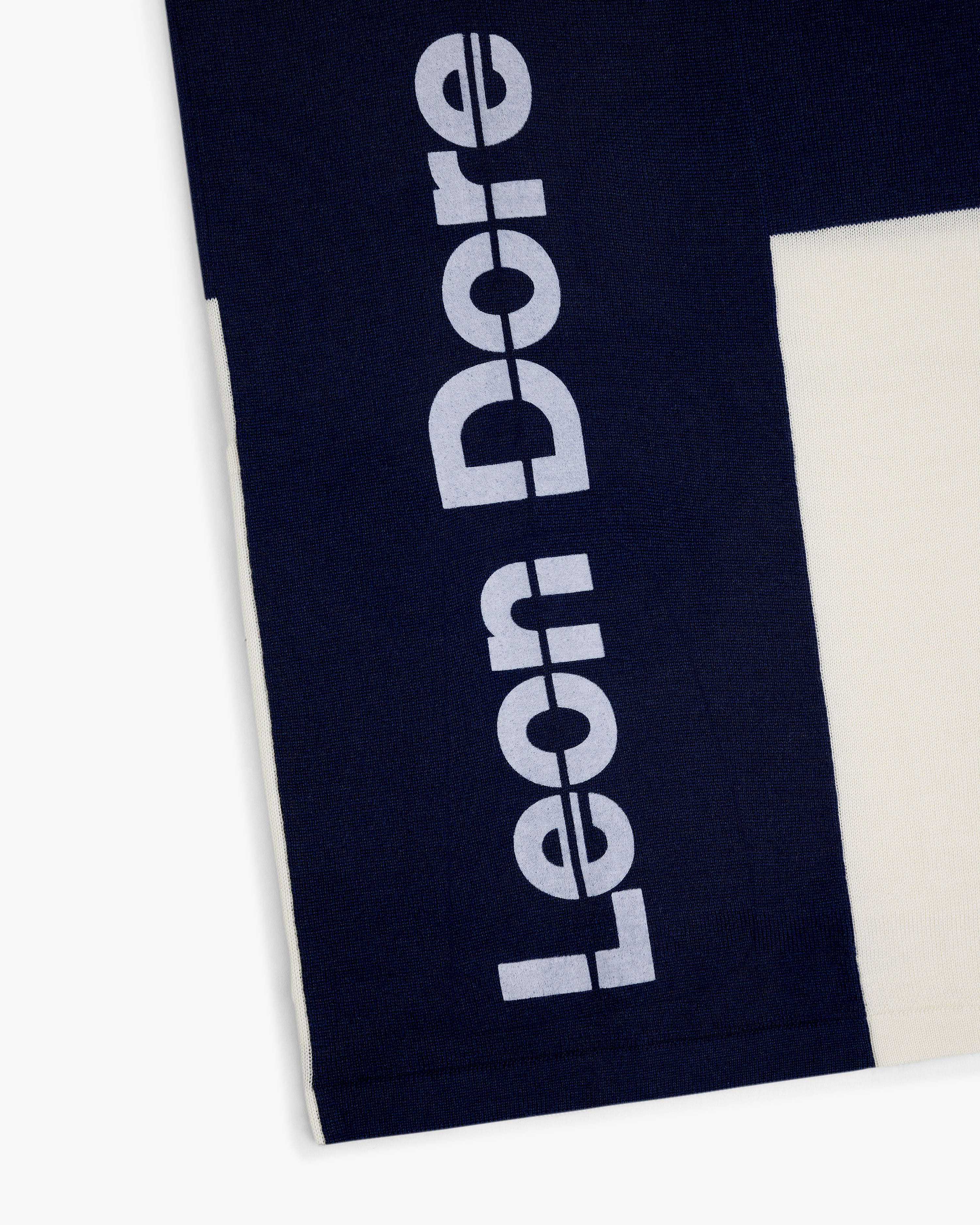 Navy Merino Wool Cycling Jersey with Leon Dore printed vertically in large white letters on the side.