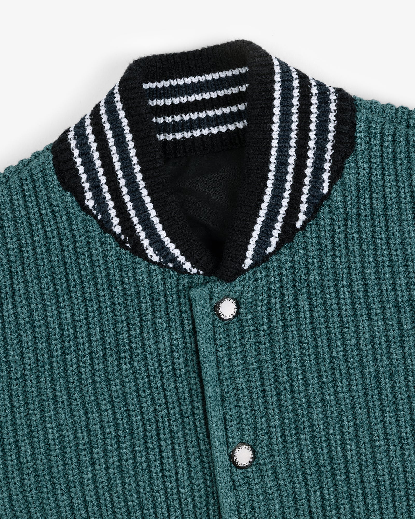 Reversible Knit Bomber Jacket with green texture, striped ribbed collar, and silver snap buttons shown close-up.