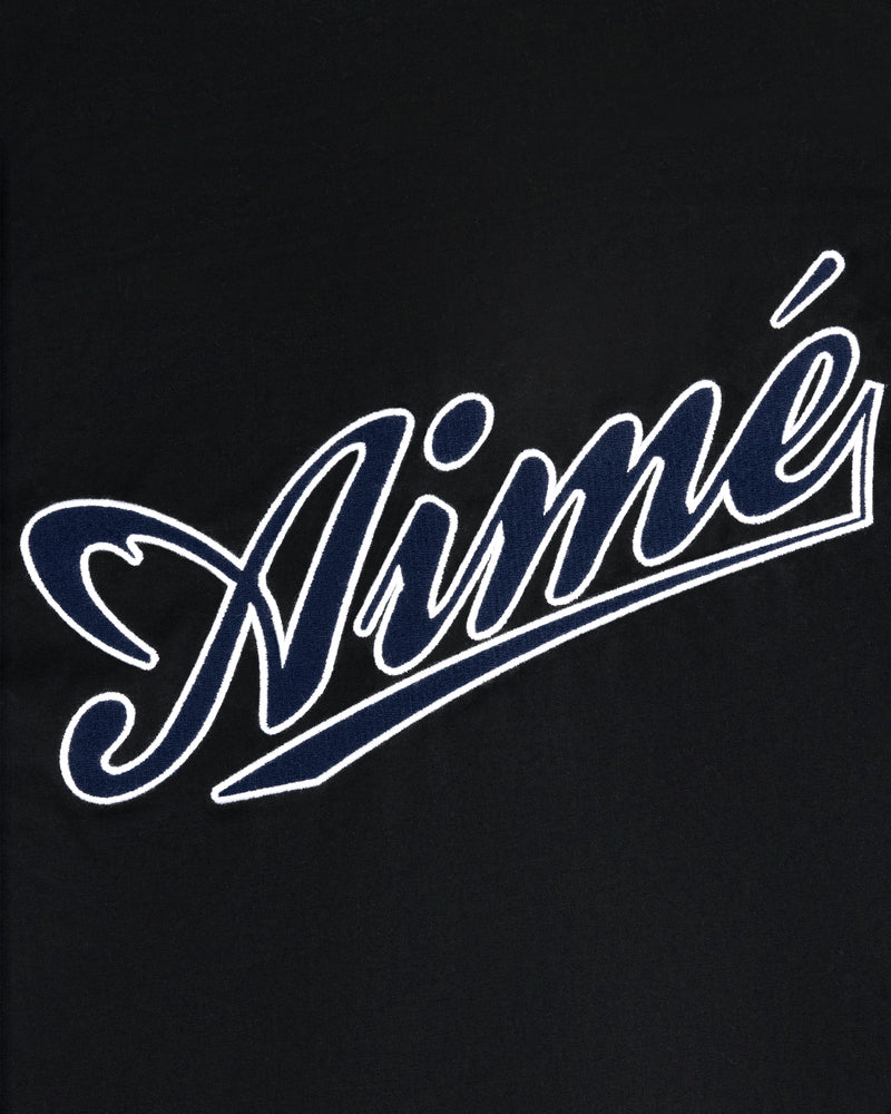 White outlined script word Aimé on black, in bold cursive, featured on the Reversible Knit Bomber Jacket.