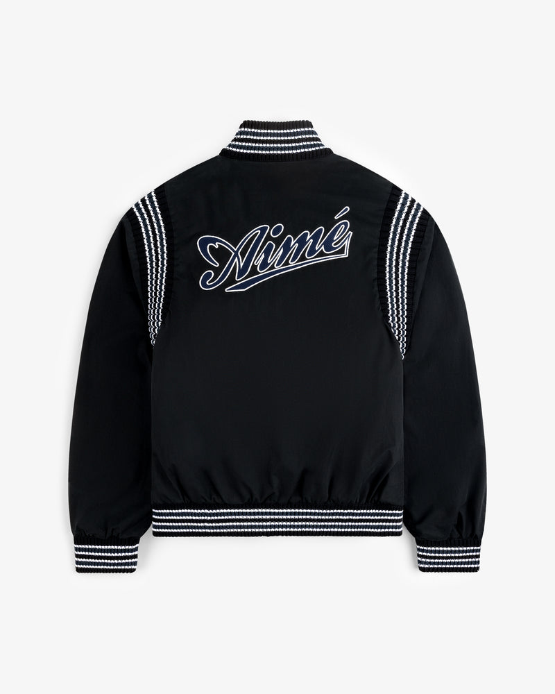 Reversible Knit Bomber Jacket with black body, white striped cuffs and collar, and Aimé script on the back.