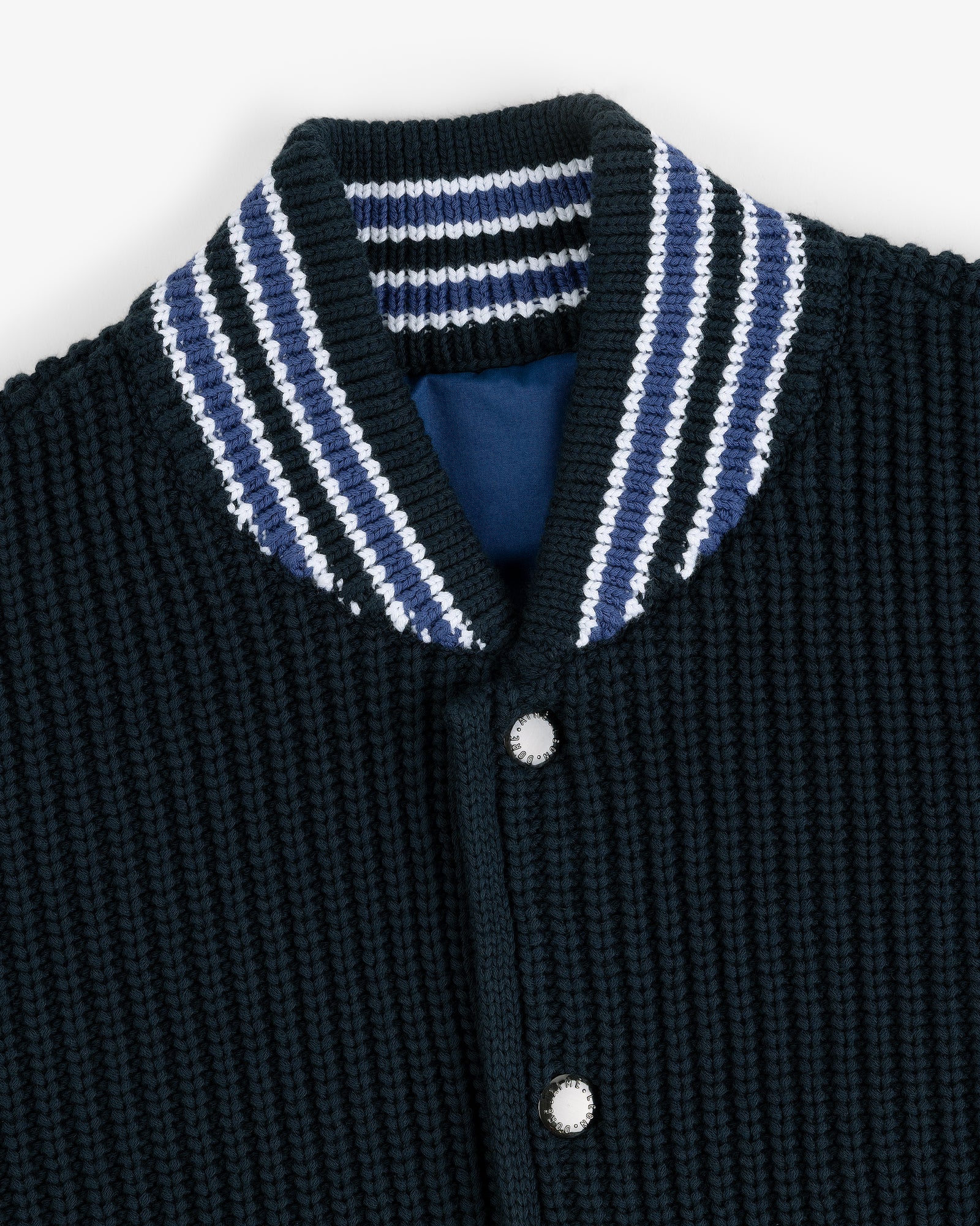 Close-up of the Reversible Knit Bomber Jacket with a blue, white, and black striped ribbed collar and snap buttons.