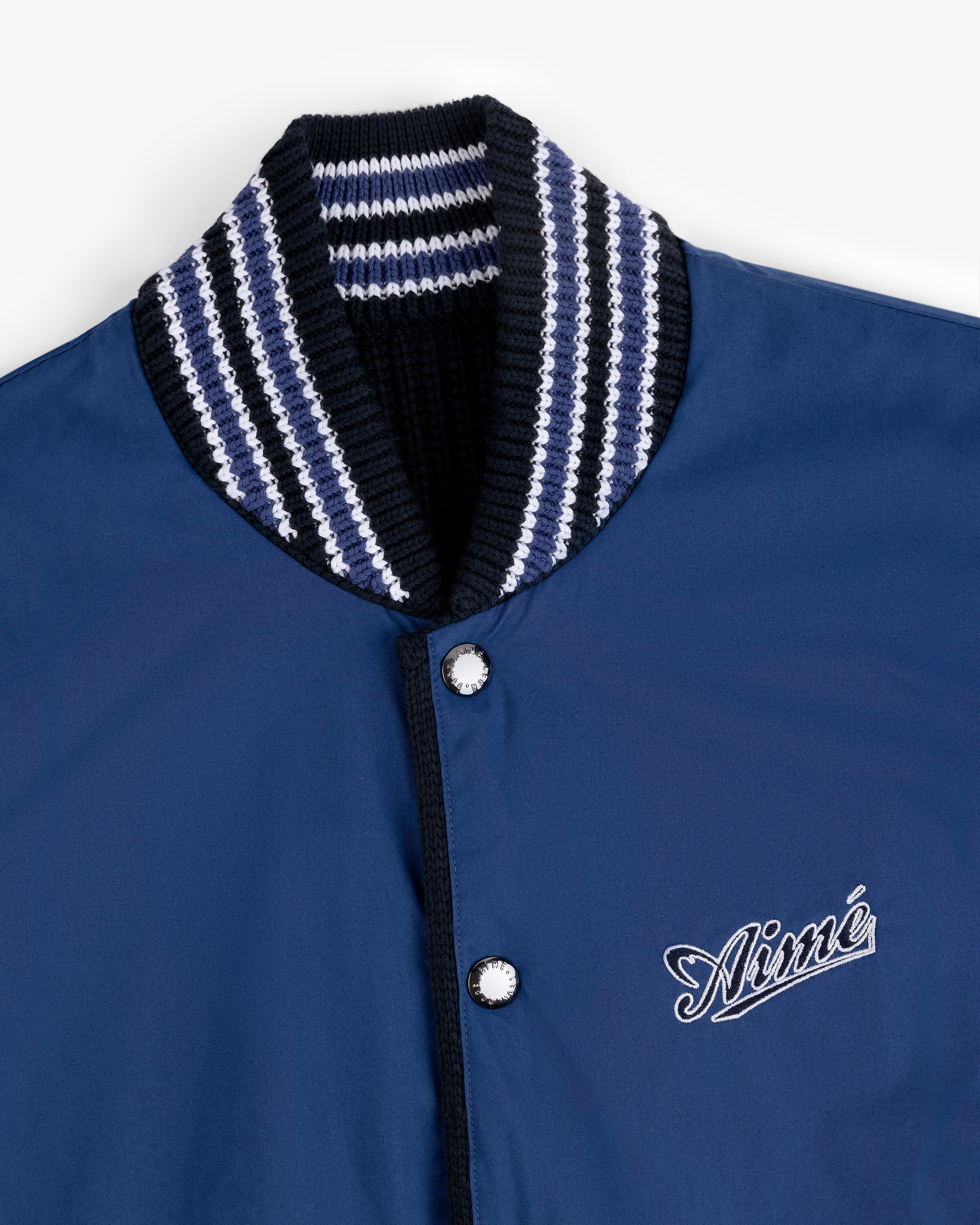 Reversible Knit Bomber Jacket in navy with striped ribbed collar and Aimé embroidered in white on the chest.
