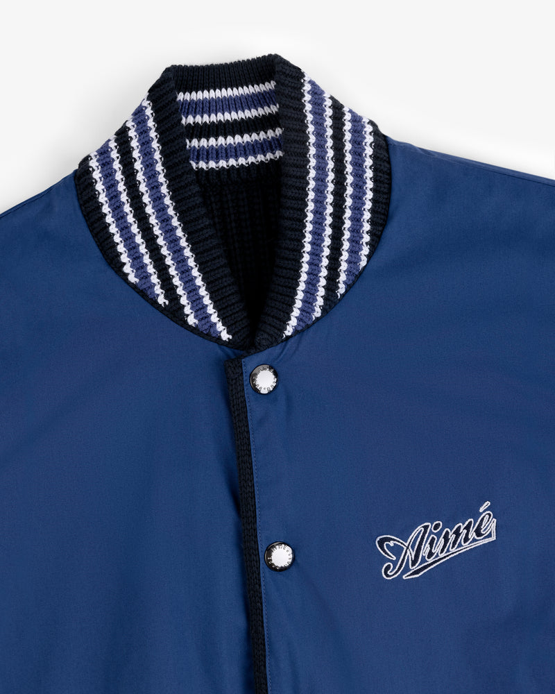 Reversible Knit Bomber Jacket in navy with striped ribbed collar and Aimé embroidered in white on the chest.
