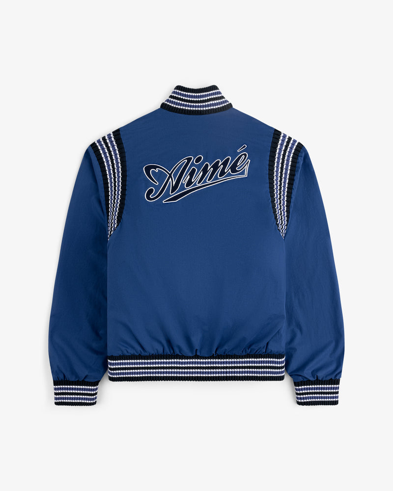 Reversible Knit Bomber Jacket in blue with black and white striped trim and Aimé script embroidered on the back.