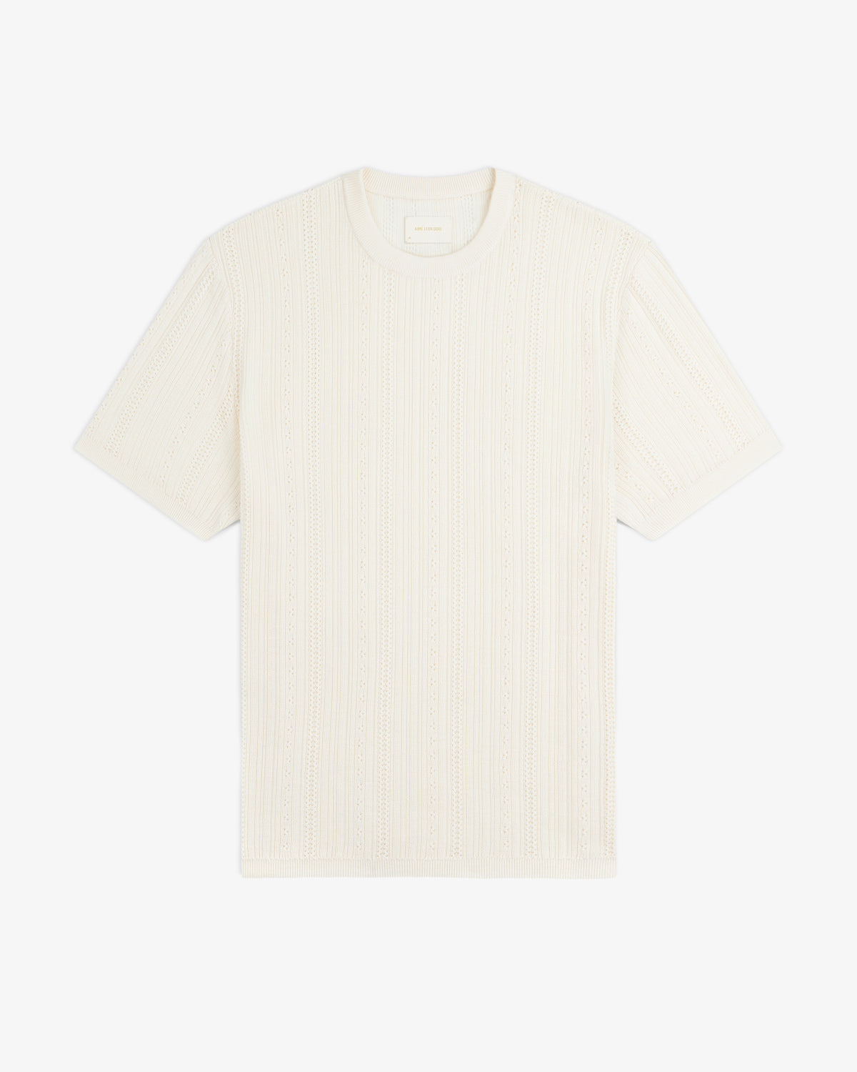 The Merino Wool Eyelet Tee is a cream short-sleeve knit with a textured pattern, shown flat on a white background.