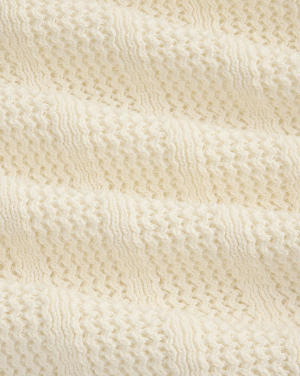 Close-up of the Racking Stitch Crewneck Sweater's soft, cream knit with a textured, wavy pattern.