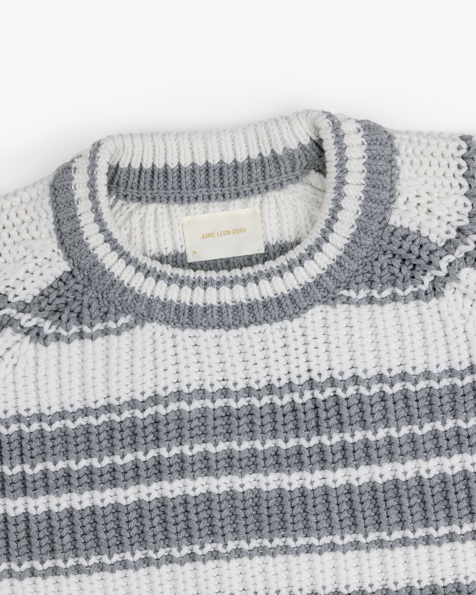 Striped Crewneck Sweater in white and gray with a ribbed neck and woven label inside the collar.