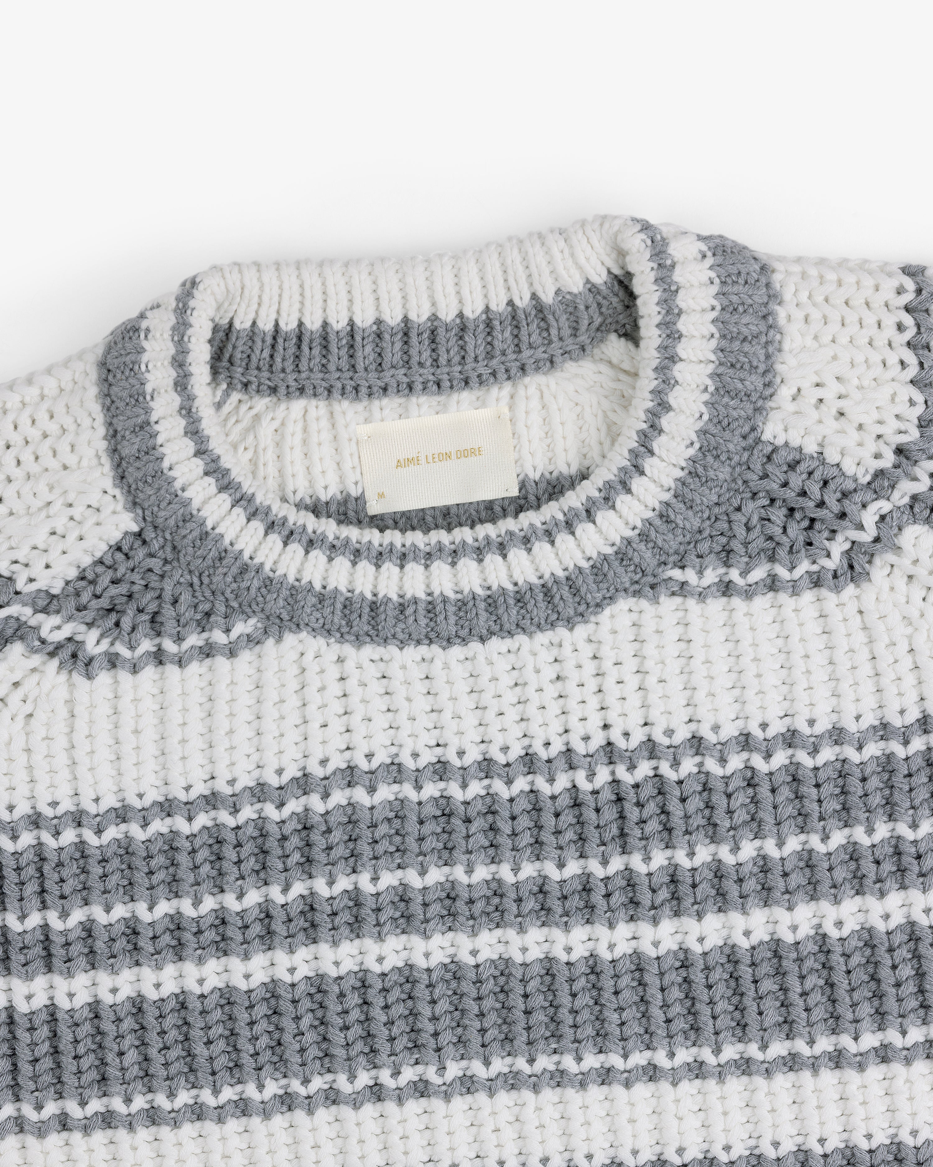 Striped Crewneck Sweater in white and gray with a ribbed neck and woven label inside the collar.