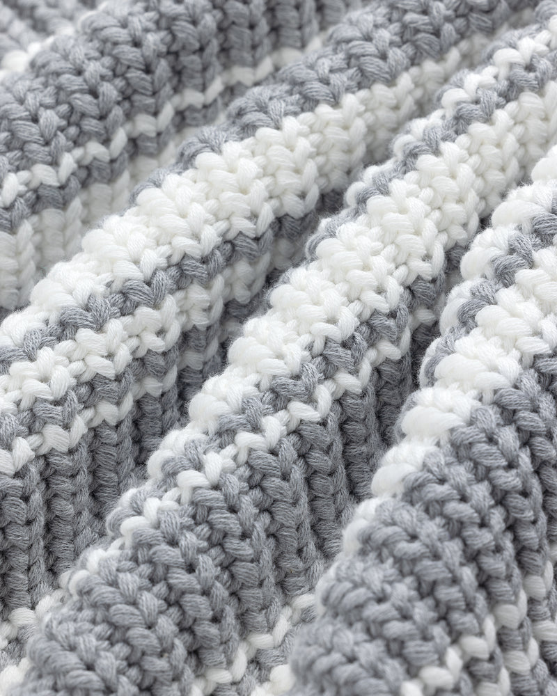 Close-up of the Striped Crewneck Sweater, featuring gray and white stripes and textured knit for a soft, cozy feel.