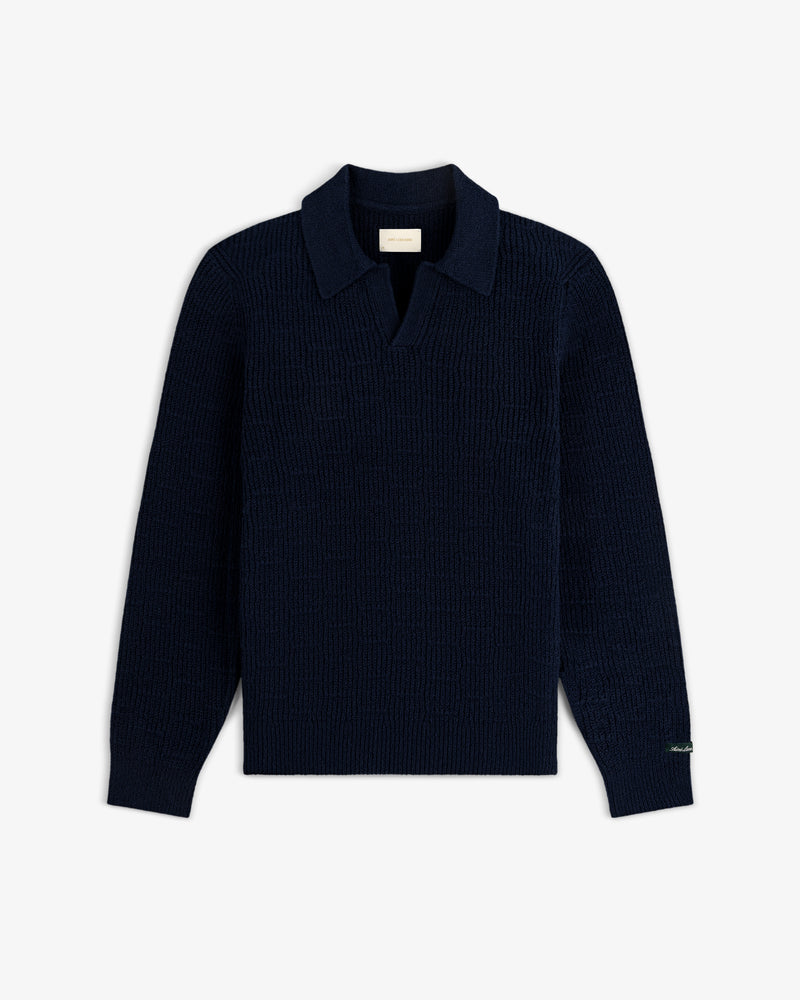 Long-Sleeve Boucle Polo in navy with collar and sleeve label, shown on a white background.