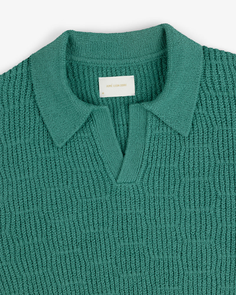 Long-Sleeve Boucle Polo in teal with textured knit, collared design, and V-neck opening on a white background.