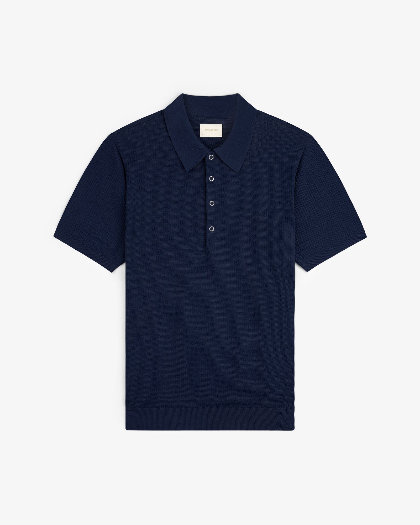 Navy Knit Polo with short sleeves, classic collar, and three buttons, laid flat on a white background.