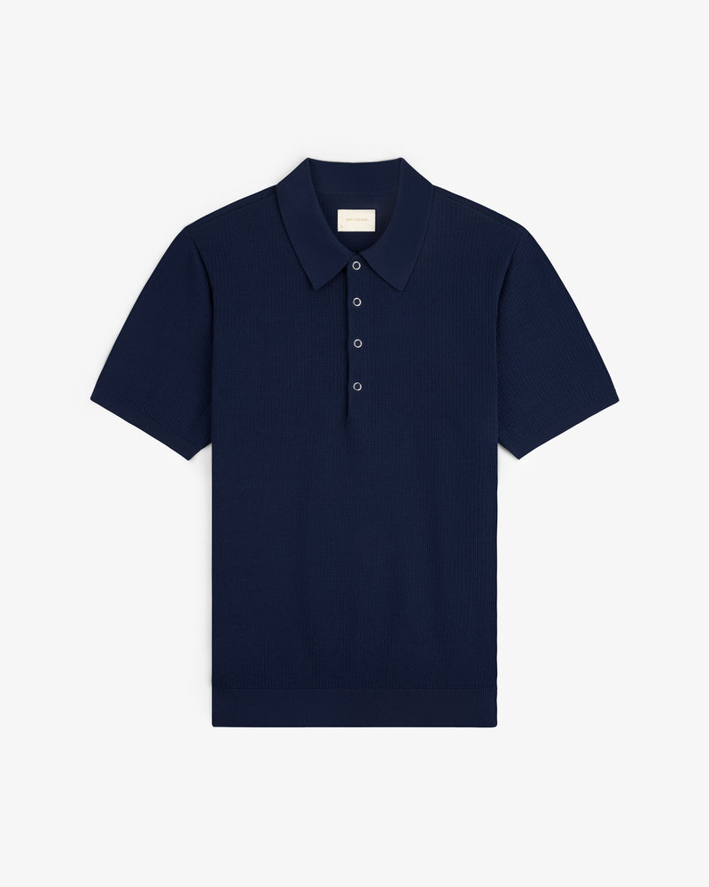 Navy Knit Polo with short sleeves, classic collar, and three buttons, laid flat on a white background.