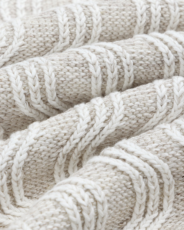 Close-up of the Linen Blend Cable Knit Sweater, featuring a soft, cream-colored textured cable pattern.