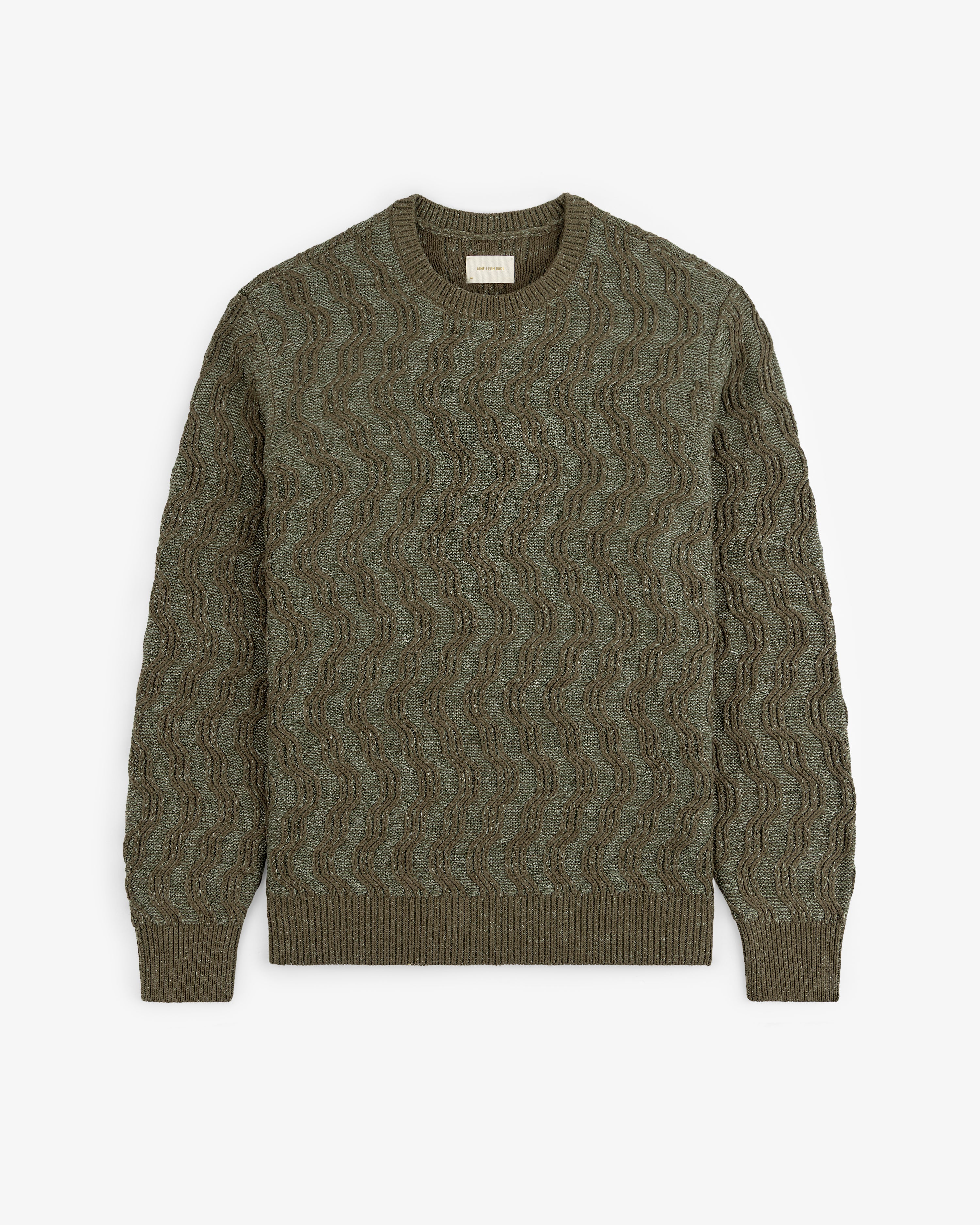 Olive green Linen Blend Cable Knit Sweater with a wavy knit pattern, shown flat on a white background.