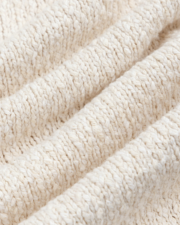 Close-up of a beige Cotton Slub Cardigan, featuring textured knit with visible horizontal ridges and soft fibers.