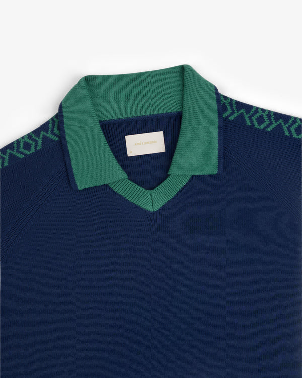 Navy blue Knit Sport Pullover with green collar and green geometric shoulder pattern, shown on white background.